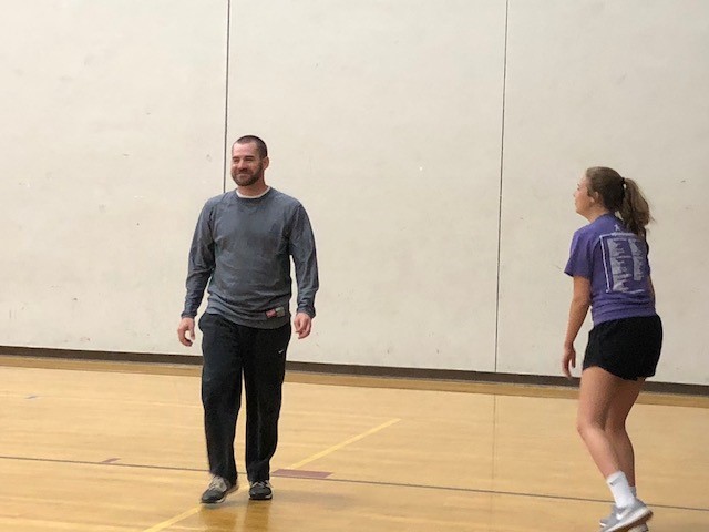 man and a girl on a basketball court